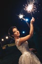 Wedding party in the street. Bride holding sparkler