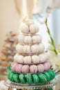 Wedding pastries on a mirror tray. Candy bar. Buffet with macaroons delicacies at the wedding. Sweet candy bar on table Royalty Free Stock Photo