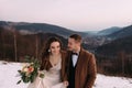 wedding photo session for a stylish couple. The bride and groom walk on top of the mountain. Lifestyle, morning dawn. Royalty Free Stock Photo