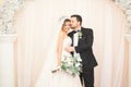 Wedding photo shoot of the newlyweds couple in a beautiful hotel posing near window Royalty Free Stock Photo