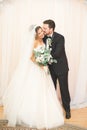 Wedding photo shoot of the newlyweds couple in a beautiful hotel posing near window Royalty Free Stock Photo