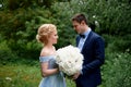 Wedding photo shoot and walk. The groom and the bride, the bride`s blue dress, and a bouquet of peonies. In the Park, on Royalty Free Stock Photo