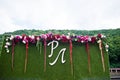 Wedding photo zone from artificial grass, flowers and big letter Royalty Free Stock Photo