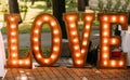 Wedding photo zone glowing love letters retro lamps