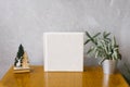 Wedding photobook in white leather cover surrounded by a Christmas tree