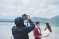 Wedding photographer in action, Wedding photography takes pictures of the bride and groom in nature. Behind the scene of Royalty Free Stock Photo