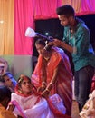 Wedding photographer in action, taking a picture of the Indian bride and groom