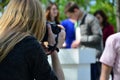 Wedding photographer in the process of his work. Professional photographer shoots a wedding ceremony. A young girl looks into the