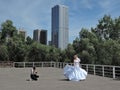 Wedding photographer takes pictures of the bride on the background of the urban landscape, fine art photos. Russia, Saratov - June