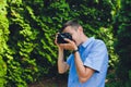 wedding photographer takes pictures of bride and groom in city. wedding couple on photo shoot. photographer in action. Royalty Free Stock Photo