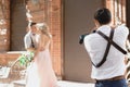 Wedding photographer takes pictures of bride and groom Royalty Free Stock Photo