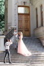 Wedding photographer takes pictures of bride and groom