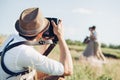 Wedding photographer takes pictures of bride and groom in nature, fine art photo