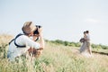 Wedding photographer takes pictures of bride and groom in nature, fine art photo Royalty Free Stock Photo