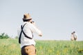 Wedding photographer takes pictures of bride and groom in nature, fine art photo Royalty Free Stock Photo