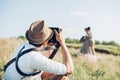 Wedding photographer takes pictures of bride and groom in nature, fine art photo Royalty Free Stock Photo