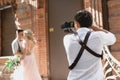 Wedding photographer takes pictures of bride and groom Royalty Free Stock Photo