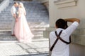 Wedding photographer takes pictures of bride and groom Royalty Free Stock Photo