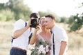 Wedding photographer takes pictures of bride and groom Royalty Free Stock Photo