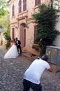 Wedding photographer taking a photo of a married couple