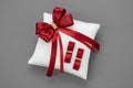 Wedding Pillow for Rings decorated with red ribbons. Royalty Free Stock Photo