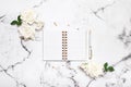 Marble table flat lay with open notebook and pen for wedding planning, bloggers, students, office