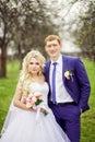 Wedding portrait of the bride and groom in the spring garden Royalty Free Stock Photo