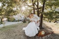 Wedding portrait. A groom in a black suit and a blonde bride in a dress and sneakers Royalty Free Stock Photo