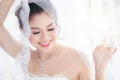 Portrait beautiful Asian bride with diamond ring in white luxury wedding dress and jewelry smiling Royalty Free Stock Photo