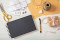 Flat lay and top view of black notebook and wedding invitations on a white wooden tabletop, copy space.