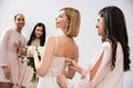 wedding preparations, bridesmaid zipping wedding dress