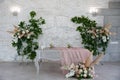 Wedding presidium in restaurant, free space. Wedding banquet table for newlyweds with flowers, greenery, pink cloth . Lush floral