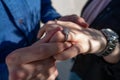 Wedding proposal, a man putting a ring on a woman`s finger | Couple in love and getting married