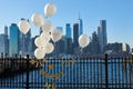 Wedding proposal with white balloons and gold lettering in Brooklyn Bridge Park, NYC