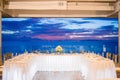 Wedding reception dinner table setting during sunset with ocean view background Royalty Free Stock Photo