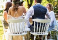 Bride and groom with guests at wedding reception outside in the backyard. Royalty Free Stock Photo