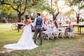Bride and groom holding hands at wedding reception outside in the backyard. Royalty Free Stock Photo