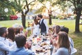 Bride and groom with guests at wedding reception outside in the backyard. Royalty Free Stock Photo