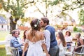 Bride and groom kissing at wedding reception outside in the backyard. Royalty Free Stock Photo