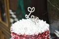 Wedding red white cake on a table with topping Royalty Free Stock Photo