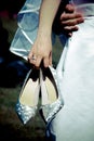 Bride holding silver shoes Royalty Free Stock Photo