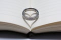 Wedding Ring Band on Book Spine with Heart Shadow Royalty Free Stock Photo
