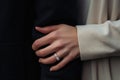 Wedding ring on the finger of the bride and groom, Close up of caucasian couple holding hands including engagement ring, AI Royalty Free Stock Photo