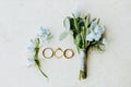 Wedding ring and flowers lay flat