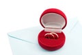 Wedding ring in a gift box on the mail envelope