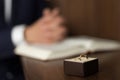 Wedding ring and hands on Bible Royalty Free Stock Photo