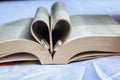 wedding ring in a heart shape bible pages