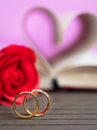 Wedding ring with pages of book curved heart shape with red rose