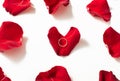 Wedding ring red box surrounded by rose petals. An offer of marriage Royalty Free Stock Photo