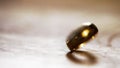 A wedding ring spins on a wooden surface